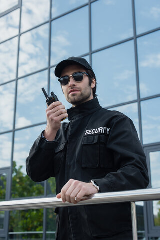 Unarmed security guard standing at a balcony making sure everyone is safe