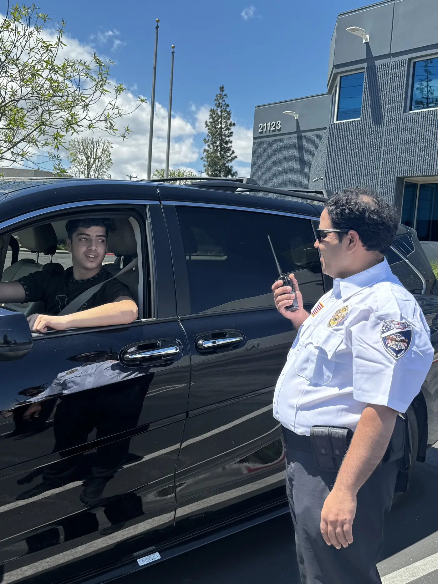 American Universal Security Guard stopping a customer to ask questions 